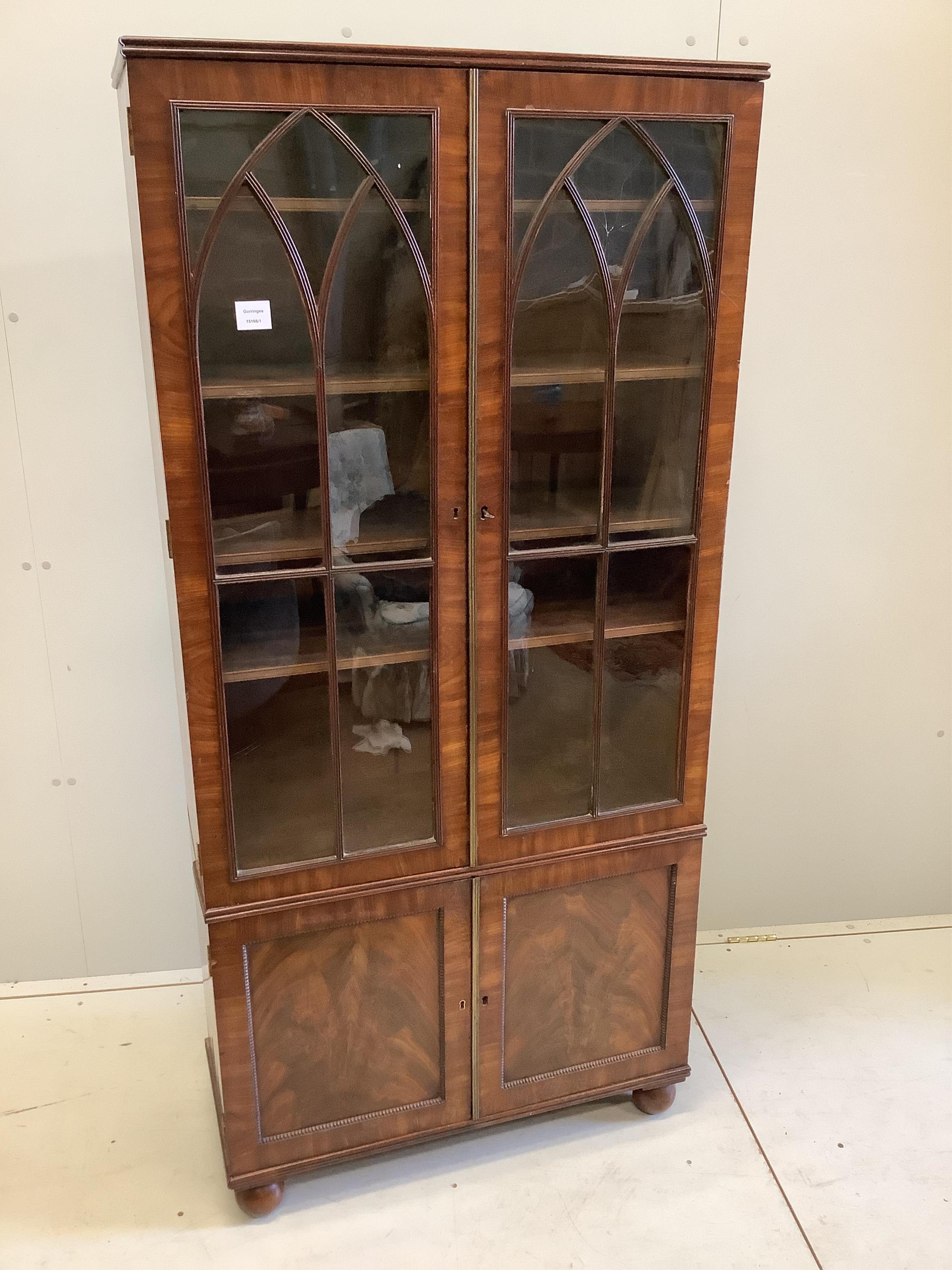 A Georgian style mahogany bookcase cupboard, width 79cm, depth 34cm, height 166cm. Condition - fair